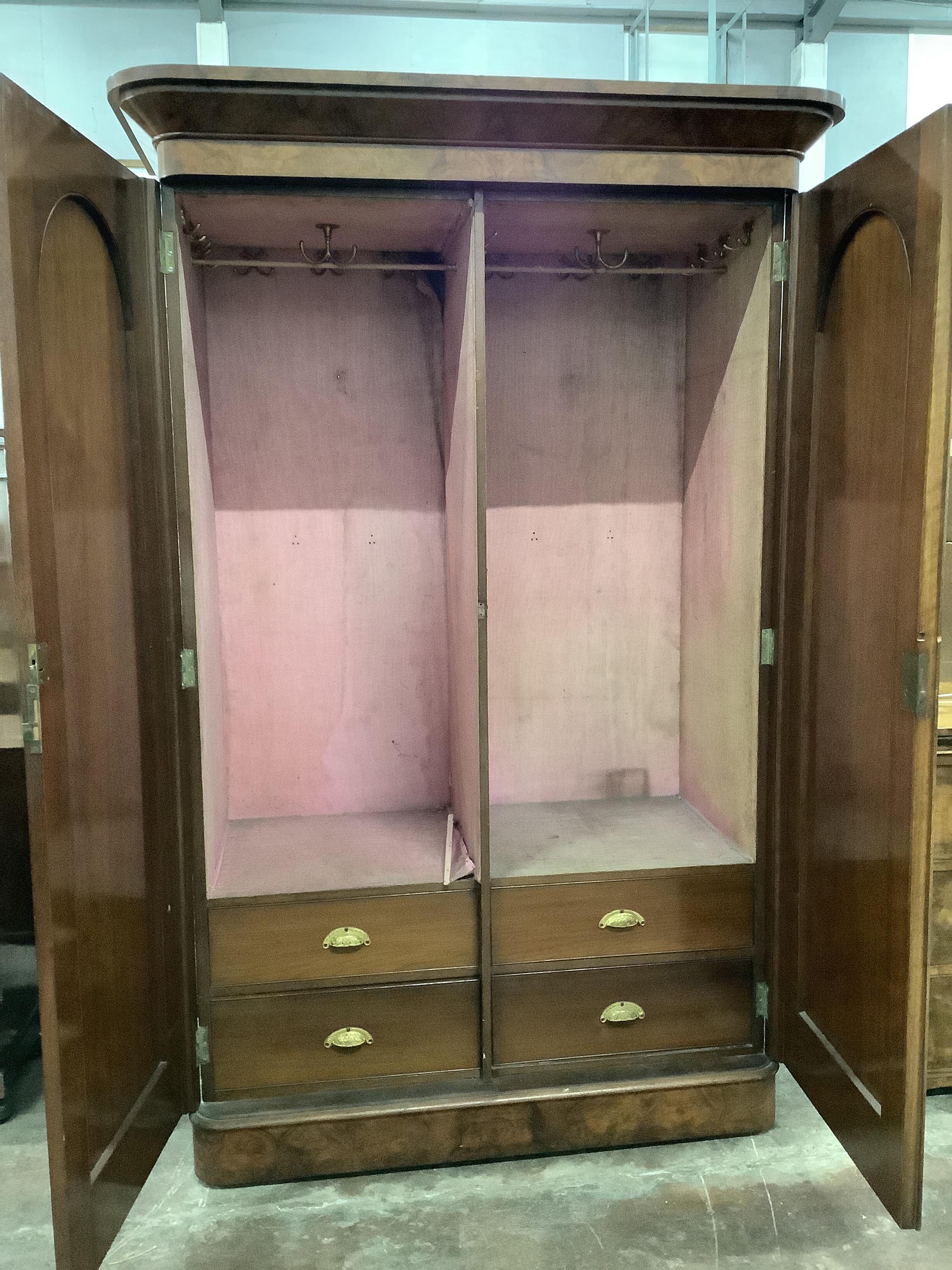 A Victorian walnut two door wardrobe, width 140cm, depth 70cm, height 214cm